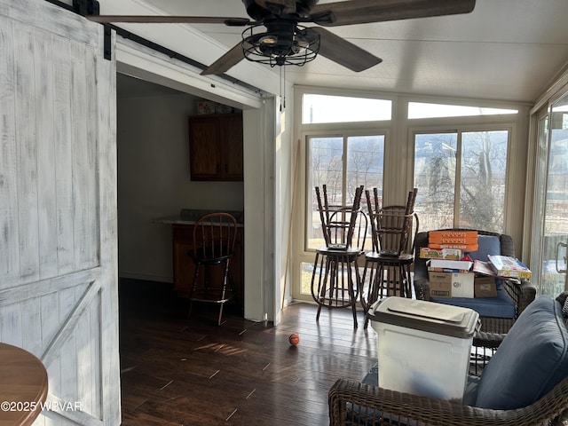 sunroom / solarium with ceiling fan and vaulted ceiling