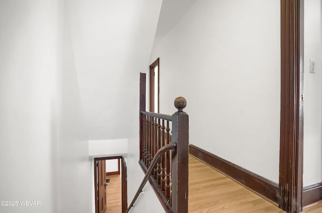 stairs featuring hardwood / wood-style floors