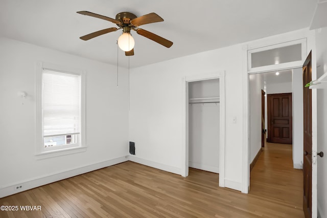 unfurnished bedroom featuring light hardwood / wood-style flooring, a closet, and ceiling fan