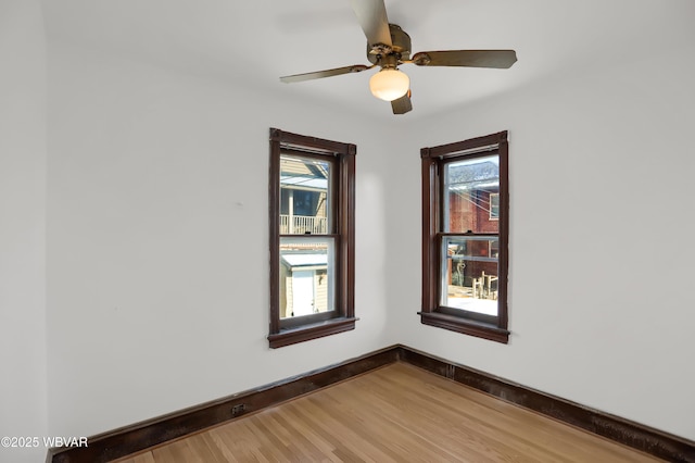 unfurnished room with hardwood / wood-style floors, plenty of natural light, and ceiling fan