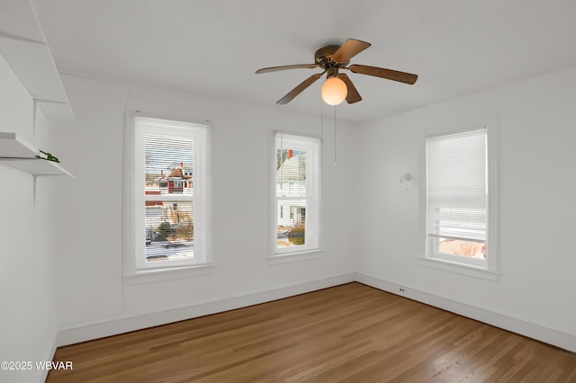 unfurnished room with ceiling fan, a healthy amount of sunlight, and light wood-type flooring