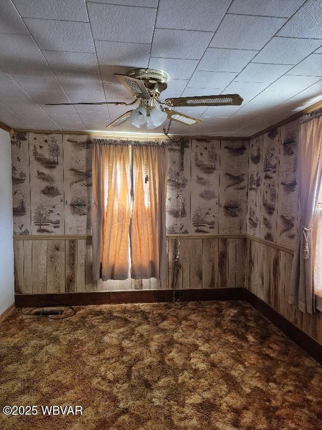 1358 W Valley Rd, Loganton, PA 17747 - spare room with wooden walls, baseboards, and a ceiling fan