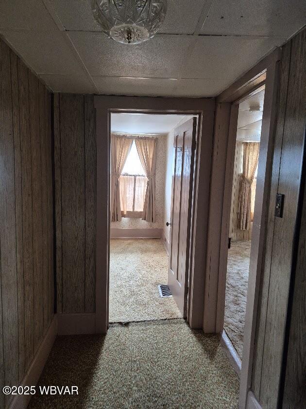 1358 W Valley Rd, Loganton, PA 17747 - hallway featuring wood walls, carpet flooring, and visible vents