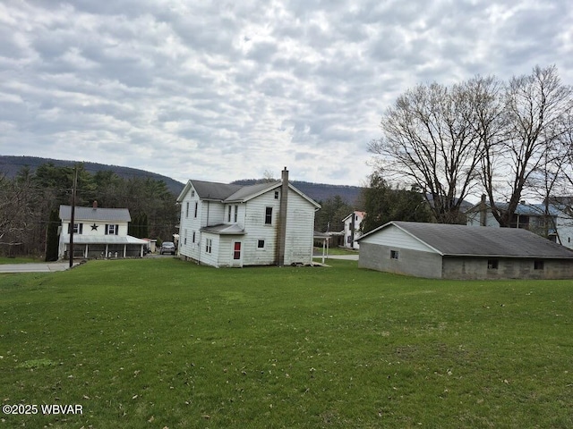 1358 W Valley Rd, Loganton, PA 17747 - view of side of property featuring a lawn and a chimney