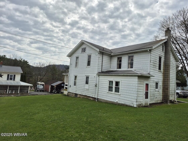 1358 W Valley Rd, Loganton, PA 17747 - rear view of house featuring a yard and a chimney