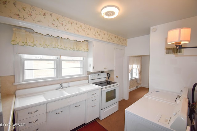 kitchen with white cabinets, light countertops, independent washer and dryer, and white electric stove