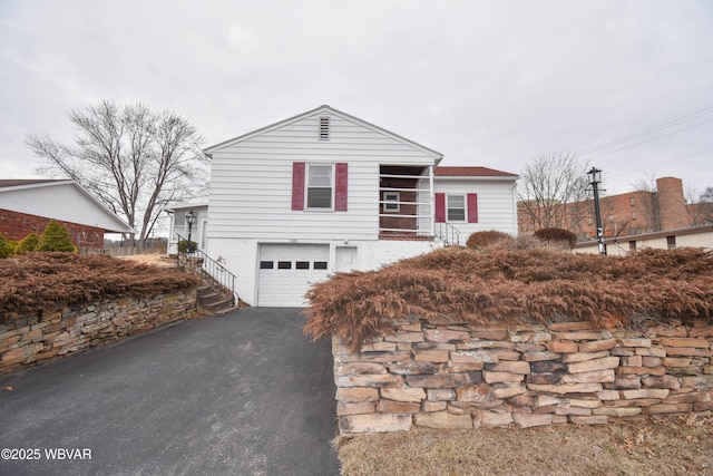 view of front of home featuring a garage and aphalt driveway