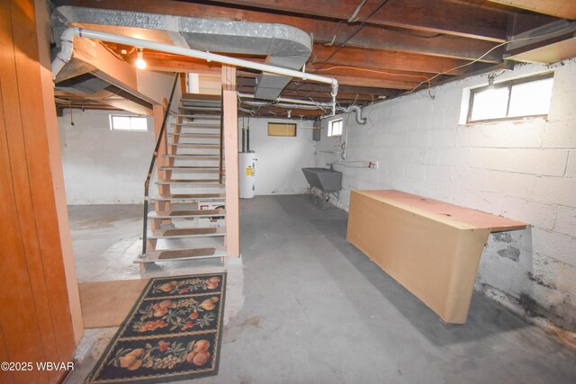 basement with water heater, stairway, and a sink