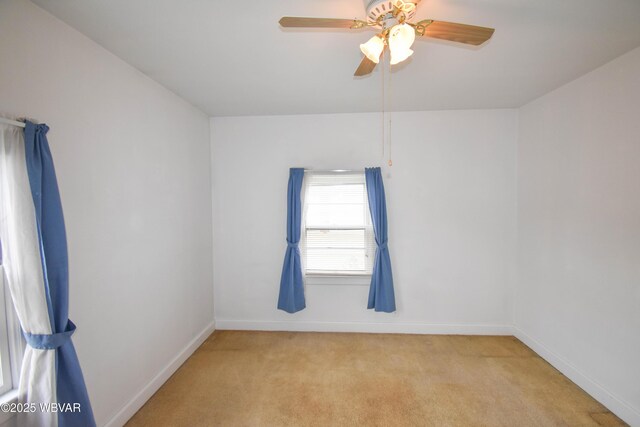 unfurnished room with light carpet, ceiling fan, and baseboards