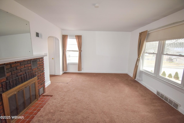 living area featuring a fireplace, carpet flooring, visible vents, and baseboards