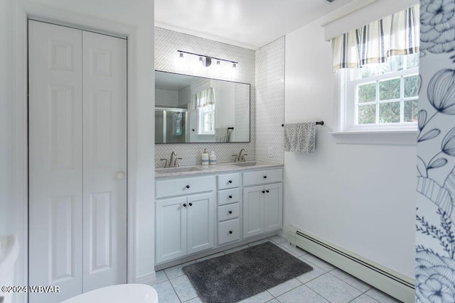 bathroom with baseboard heating, tile patterned floors, vanity, and an enclosed shower