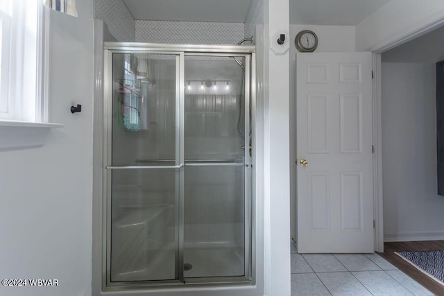 bathroom with tile patterned floors and an enclosed shower