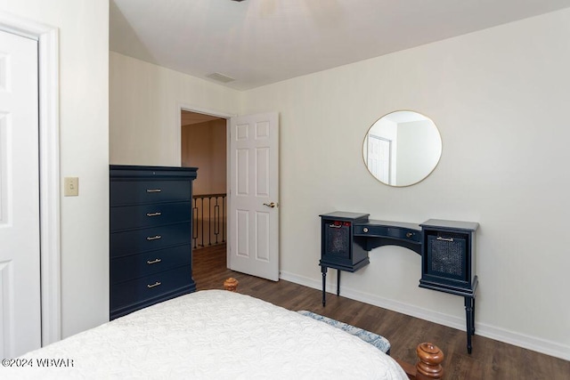 bedroom with dark hardwood / wood-style flooring