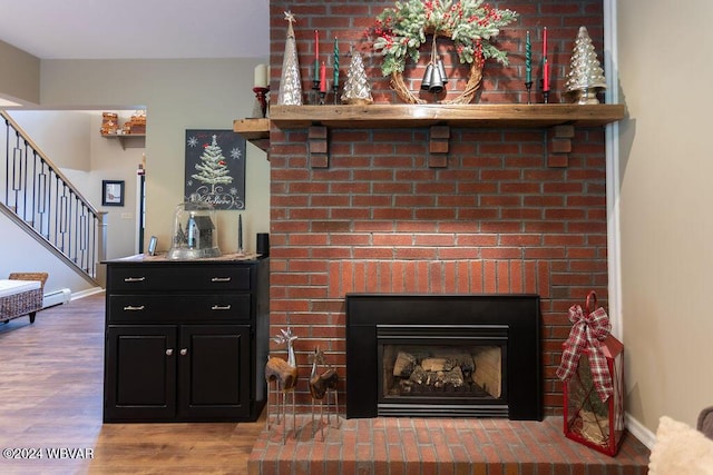 details with wood-type flooring and a brick fireplace