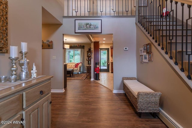 hall featuring dark wood-type flooring and a baseboard radiator