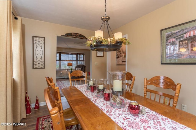 dining area featuring hardwood / wood-style floors and a notable chandelier