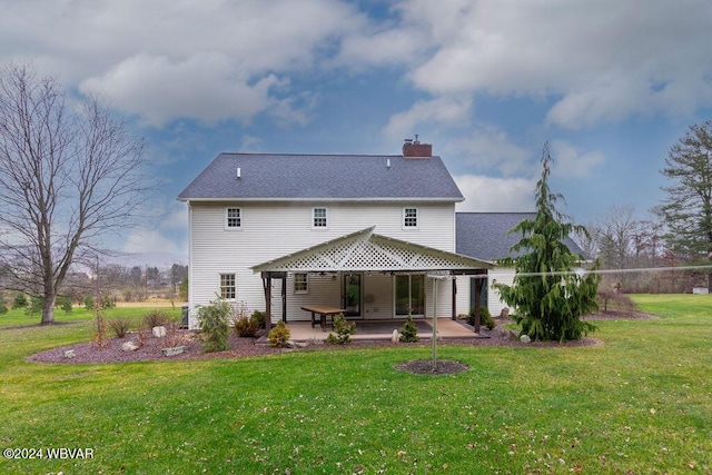 rear view of house featuring a patio and a lawn