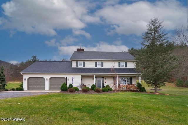 view of front facade with a front yard and a garage