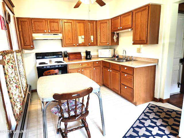 kitchen featuring a sink, white microwave, under cabinet range hood, a ceiling fan, and electric stove