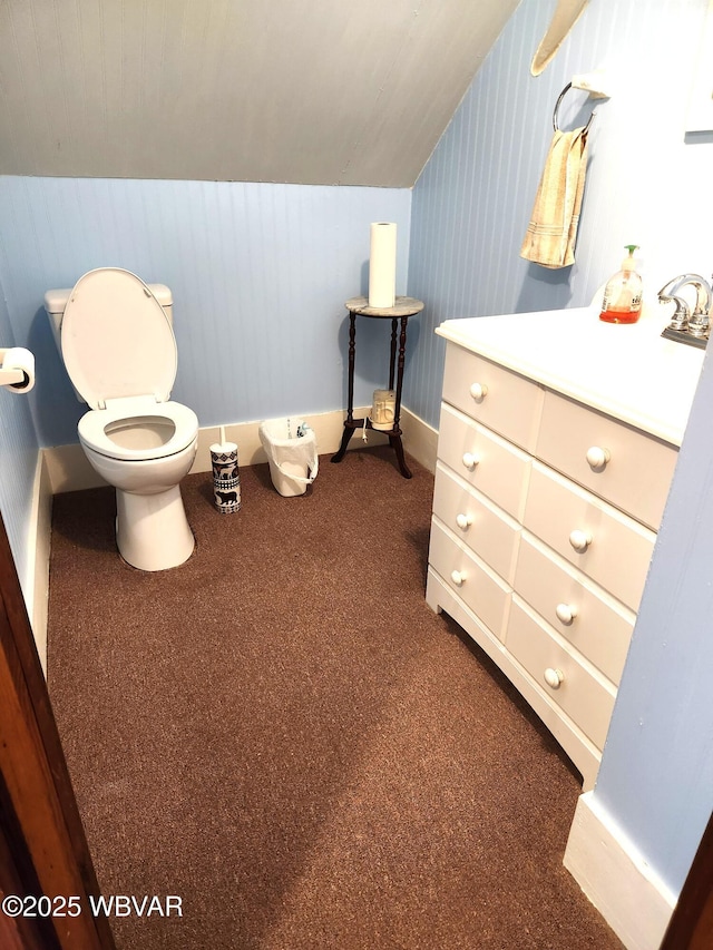 bathroom featuring toilet, baseboards, vanity, and carpet