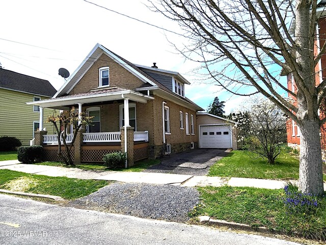 121 Fountain St, Jersey Shore, PA 17740 - view of front of property featuring driveway, an outbuilding, brick siding, covered porch, and a garage