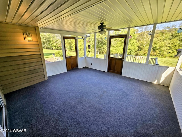 unfurnished sunroom featuring ceiling fan