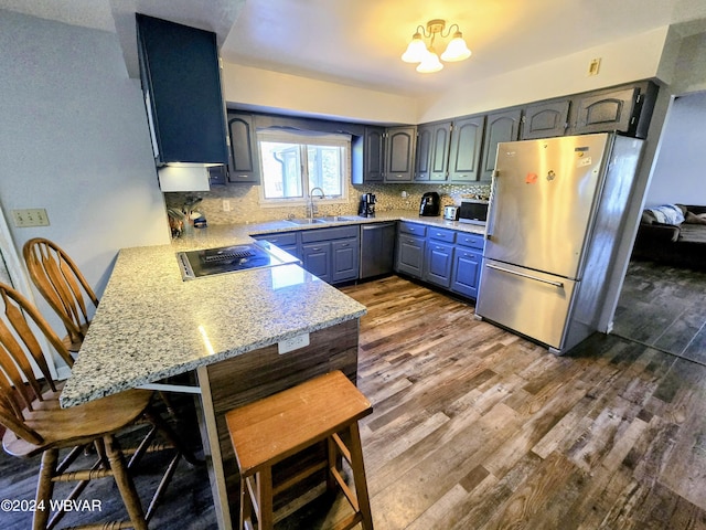 kitchen featuring light stone counters, sink, dark wood-type flooring, and appliances with stainless steel finishes