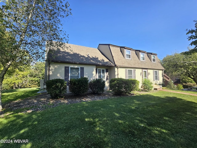 cape cod home with a front lawn