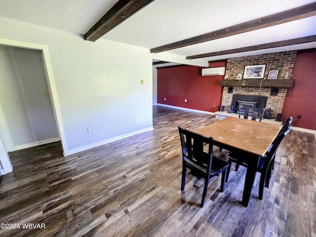 dining room with dark hardwood / wood-style floors, beam ceiling, a fireplace, and a wall mounted AC