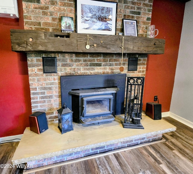 room details featuring hardwood / wood-style flooring and a wood stove