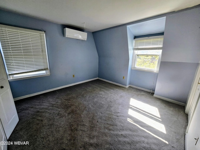 carpeted empty room featuring a wall unit AC