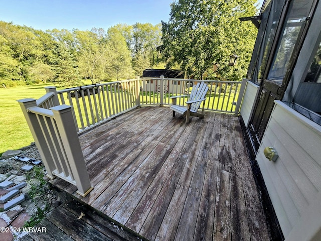 wooden terrace featuring a lawn