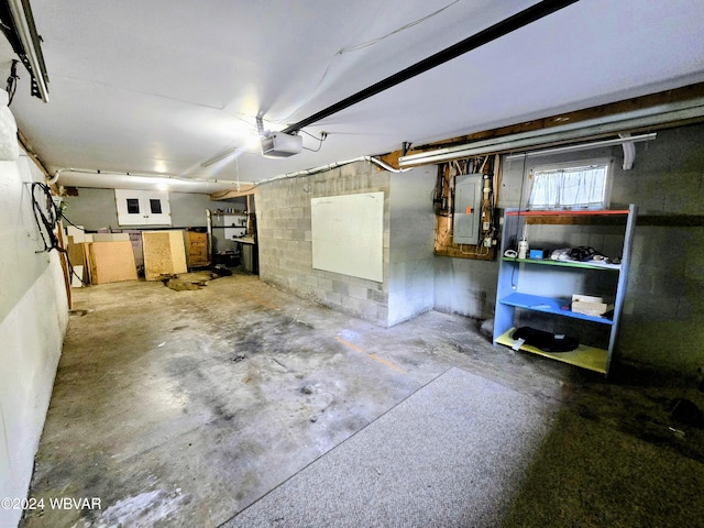 garage with electric panel and a garage door opener