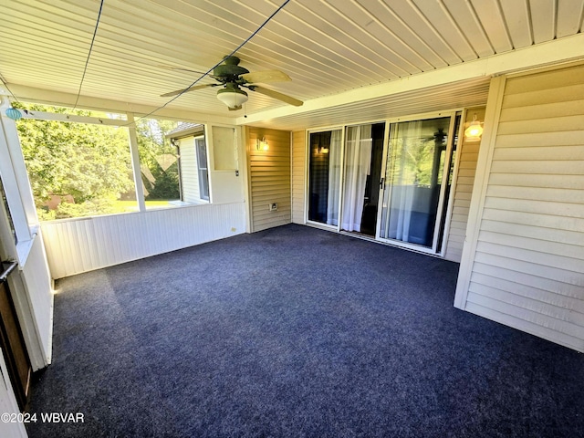 unfurnished sunroom with ceiling fan