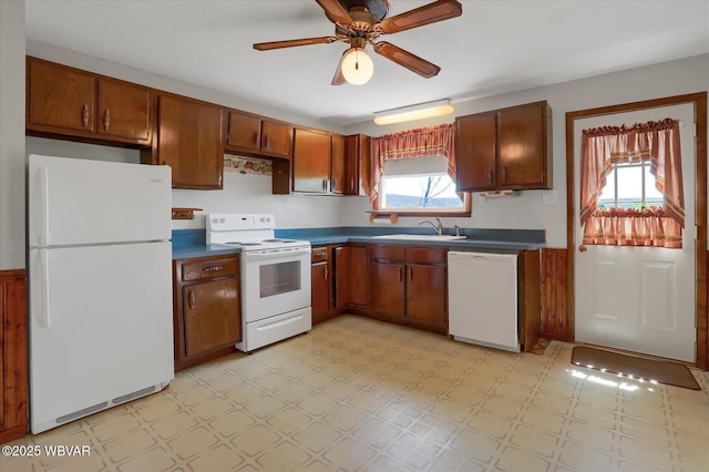 6553 Jacks Hollow Rd, Williamsport, PA 17702 - kitchen with a sink, dark countertops, white appliances, light floors, and a ceiling fan