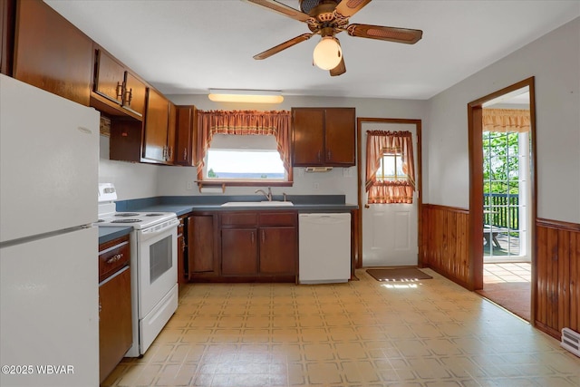 6553 Jacks Hollow Rd, Williamsport, PA 17702 - kitchen with a ceiling fan, dark countertops, wainscoting, a sink, and white appliances