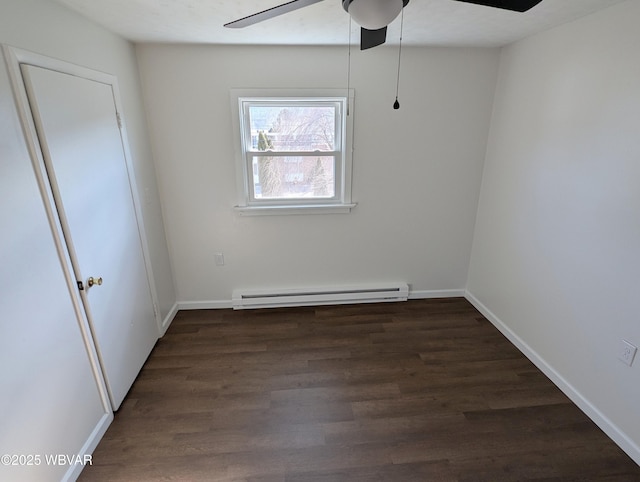 spare room with ceiling fan, a baseboard radiator, and dark hardwood / wood-style flooring