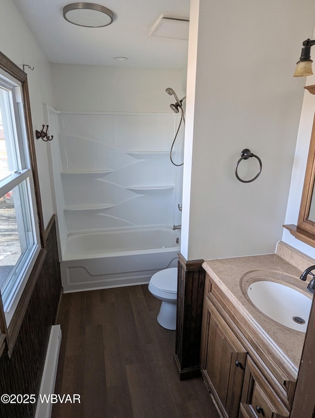 full bathroom featuring vanity, toilet, shower / washtub combination, and hardwood / wood-style floors