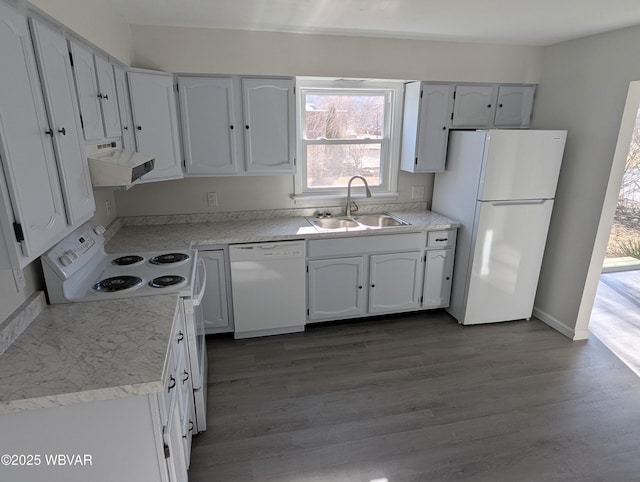 kitchen with white appliances, wood-type flooring, sink, and white cabinets