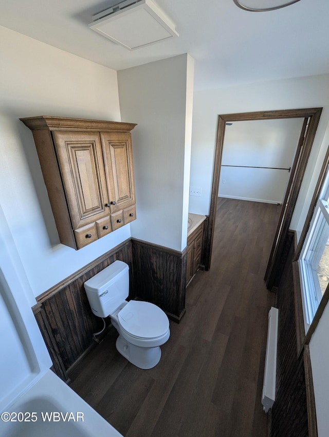 bathroom with hardwood / wood-style floors and toilet