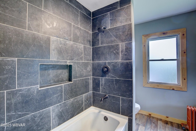320 E Central Ave, Jersey Shore, PA 17740 - bathroom with radiator heating unit, wood finished floors, baseboards, shower / washtub combination, and toilet