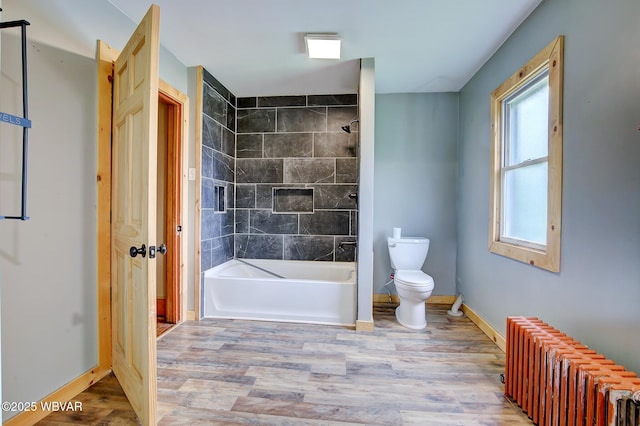 320 E Central Ave, Jersey Shore, PA 17740 - full bath with radiator heating unit, wood finished floors, baseboards, toilet, and  shower combination