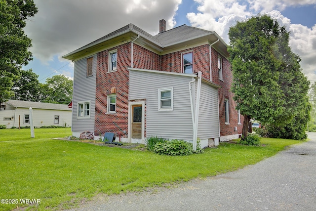 320 E Central Ave, Jersey Shore, PA 17740 - view of home's exterior with a chimney, a yard, and brick siding