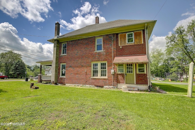 320 E Central Ave, Jersey Shore, PA 17740 - rear view of house with a lawn, brick siding, and a chimney