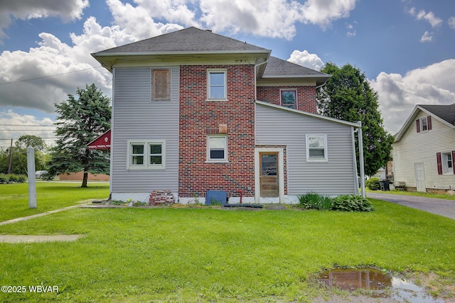 320 E Central Ave, Jersey Shore, PA 17740 - rear view of property featuring a yard, a shingled roof, and brick siding