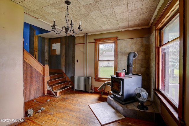 320 E Central Ave, Jersey Shore, PA 17740 - interior space featuring radiator heating unit, wood-type flooring, a chandelier, a wood stove, and crown molding