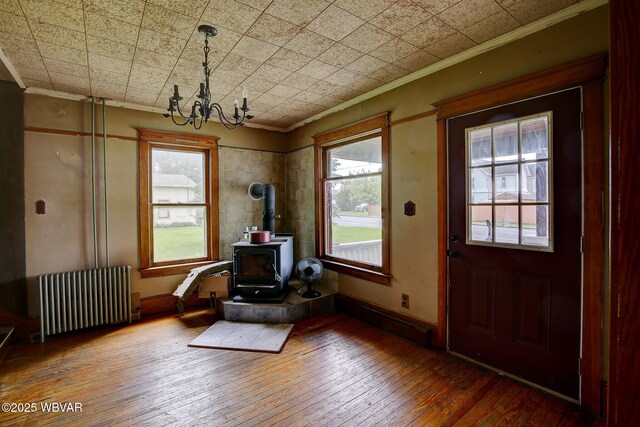 320 E Central Ave, Jersey Shore, PA 17740 - foyer entrance with radiator, a wood stove, ornamental molding, a chandelier, and hardwood / wood-style flooring