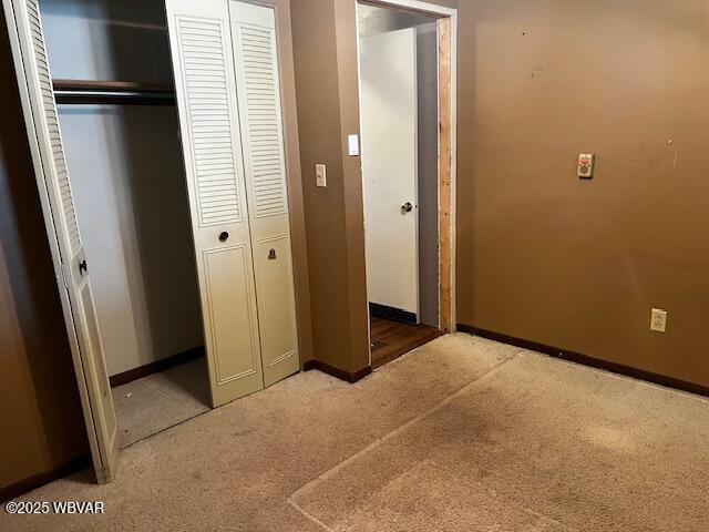 unfurnished bedroom featuring light carpet