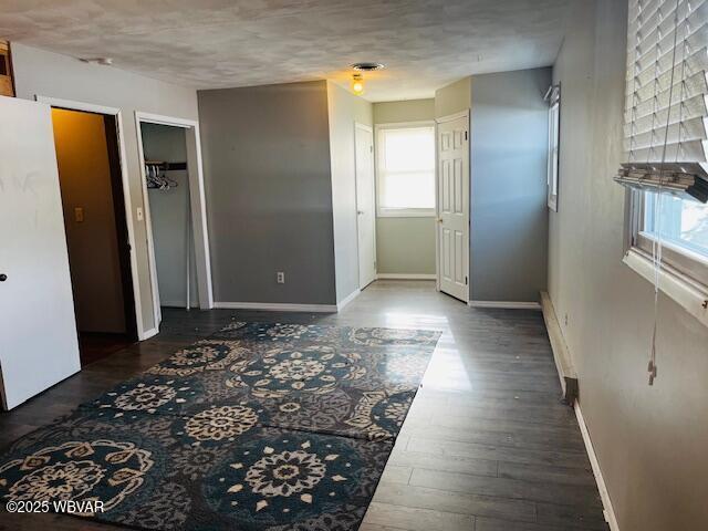 interior space with white fridge and dark wood-type flooring