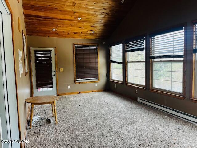 spare room featuring lofted ceiling, carpet floors, wooden ceiling, and baseboard heating